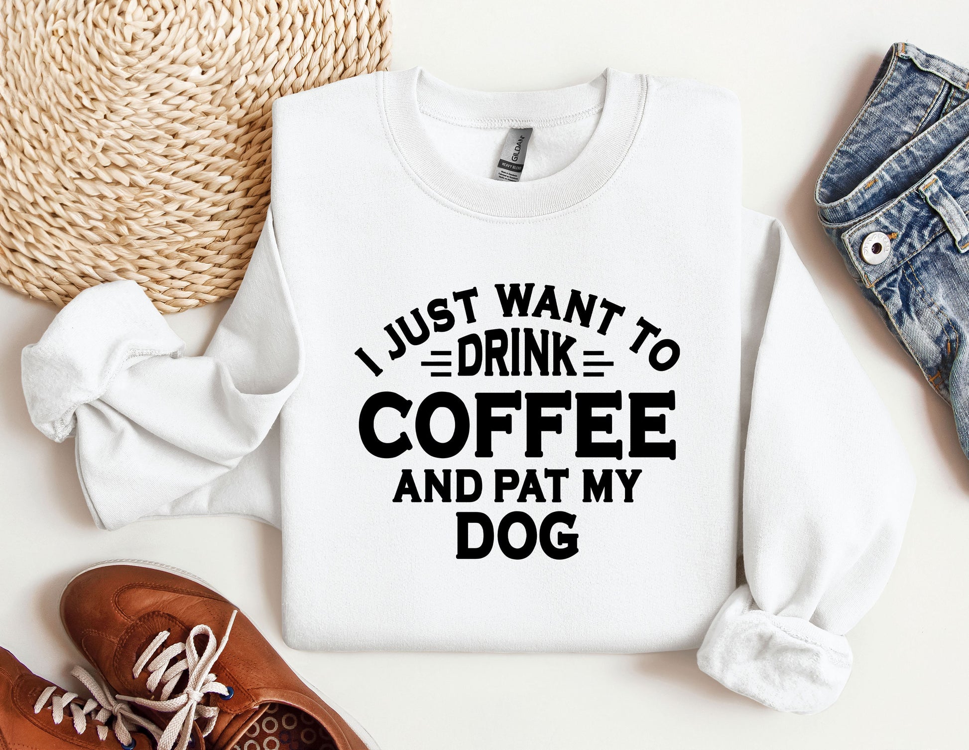 a white sweatshirt with a black print that says i just want to drink coffee and