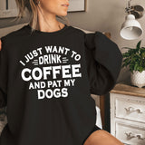 a woman sitting on a bed wearing a black sweatshirt that says i just want to