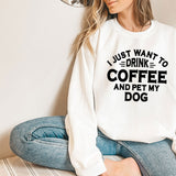 a woman sitting on the floor wearing a sweatshirt that says i just want to drink