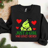 a black shirt with a green grin on it