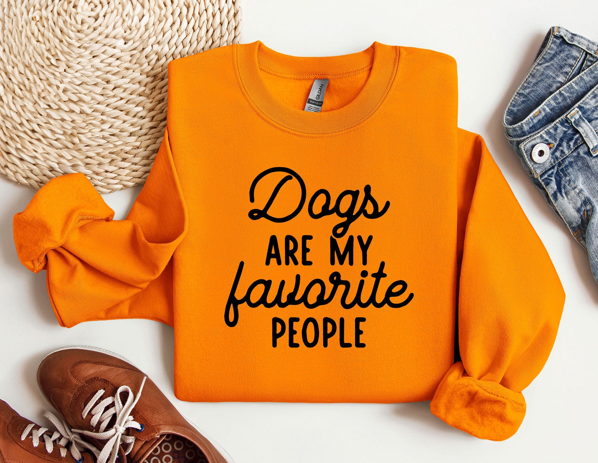 a pair of shoes and an orange sweatshirt with the words dogs are my favorite people