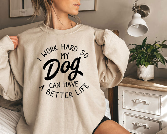 a woman wearing a sweatshirt that says i work hard so my dog can have a