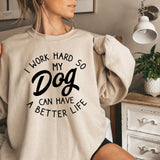 a woman wearing a sweatshirt that says i work hard so my dog can have a
