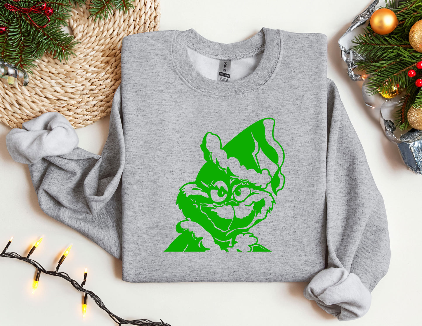 a grey sweatshirt with a green cat on it