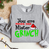 a grey sweatshirt with a green and red grin on it