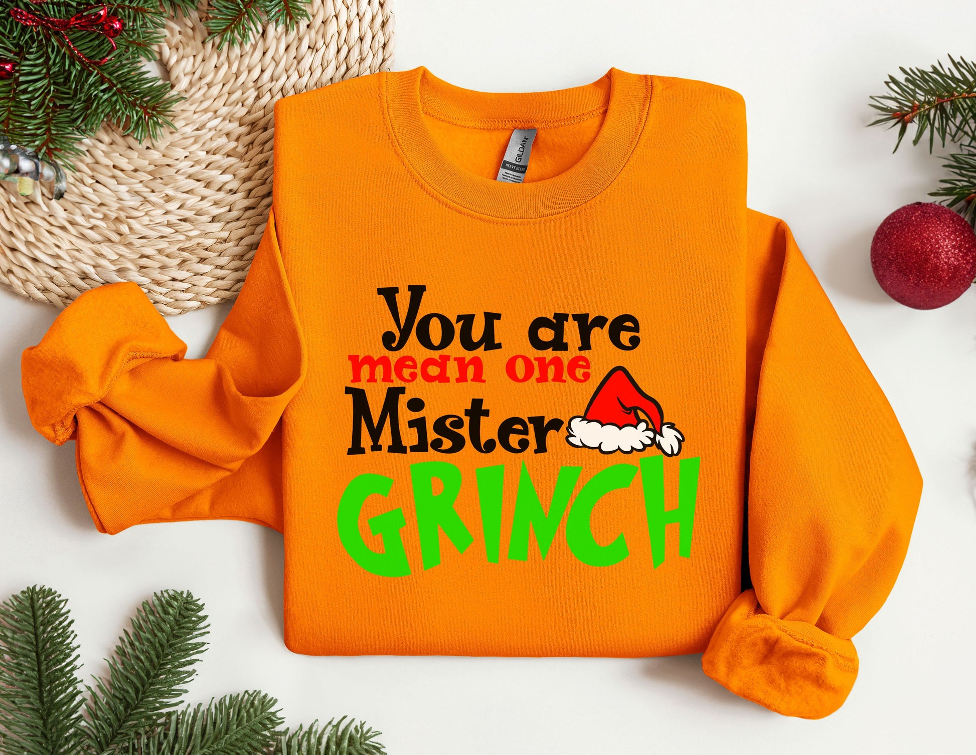 an orange sweater with the words you are mean one mister grin on it