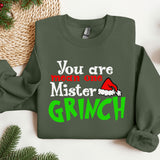 a green sweater with a santa hat on it