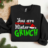 a black sweater with a green grin on it