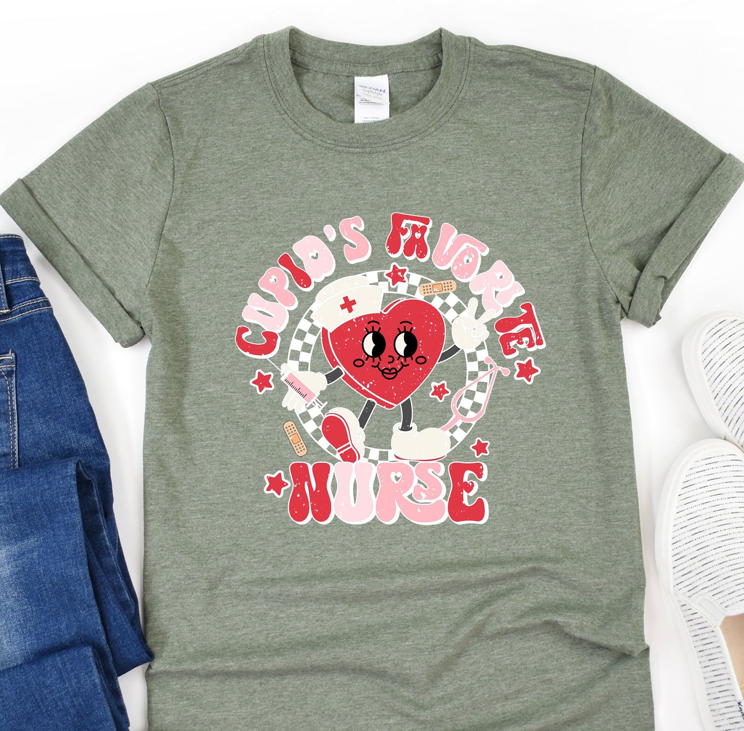 a t - shirt with a heart on it next to a pair of jeans