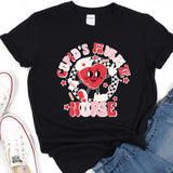 a black t - shirt with a red heart on it