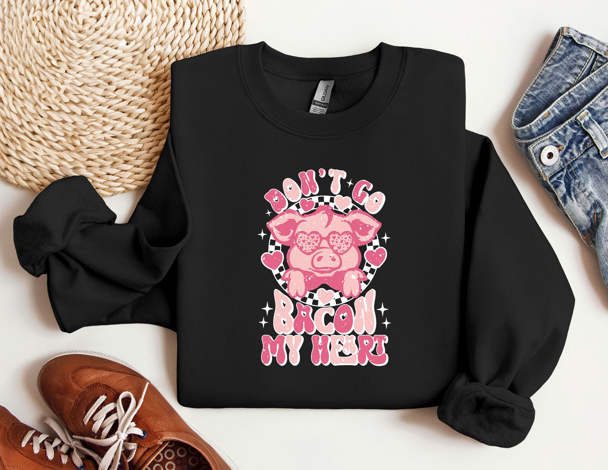 a black shirt with a pink pig on it