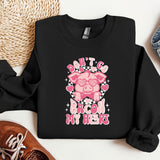 a black shirt with a pink pig on it
