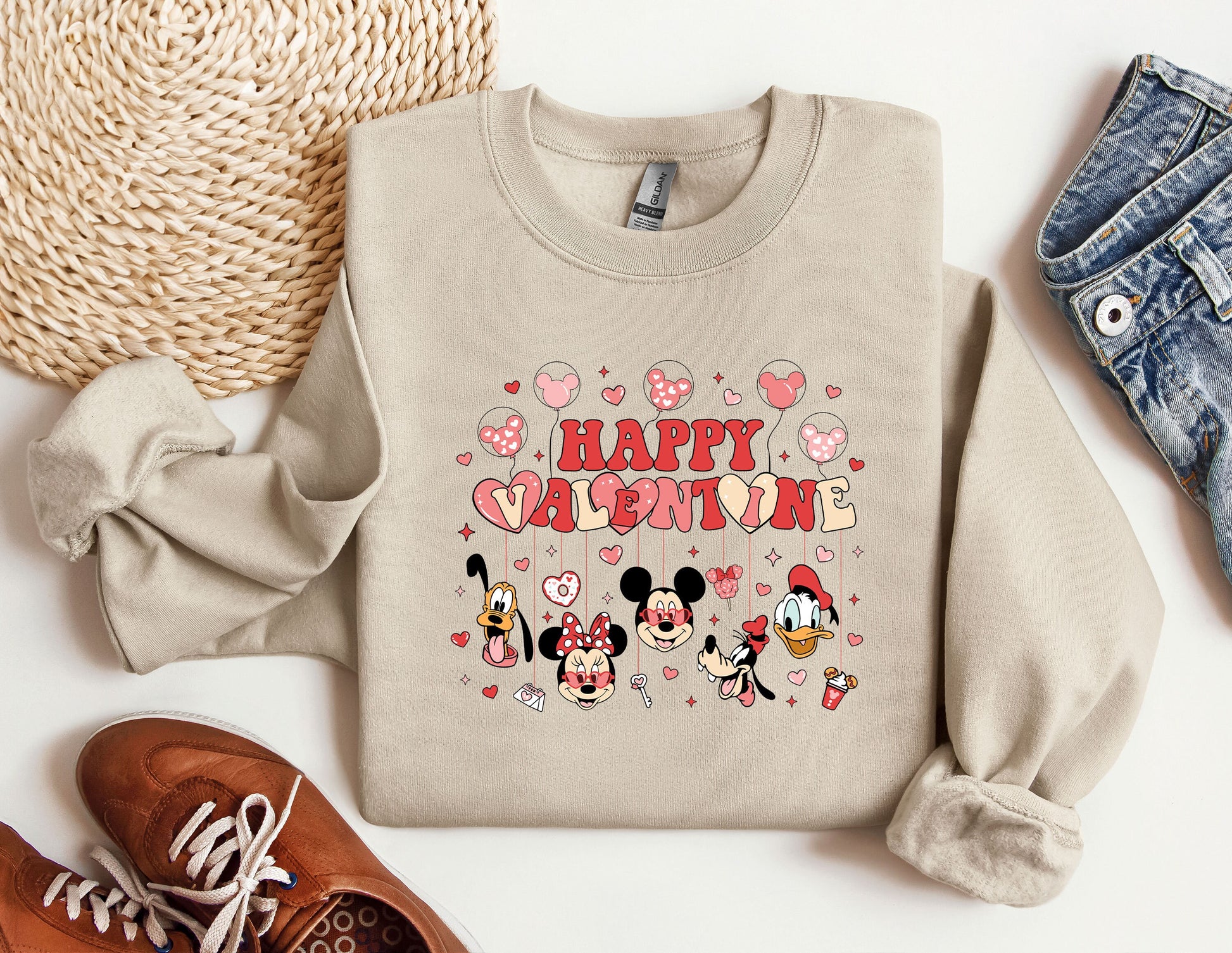 a pair of sneakers and a sweater with mickey mouse on it