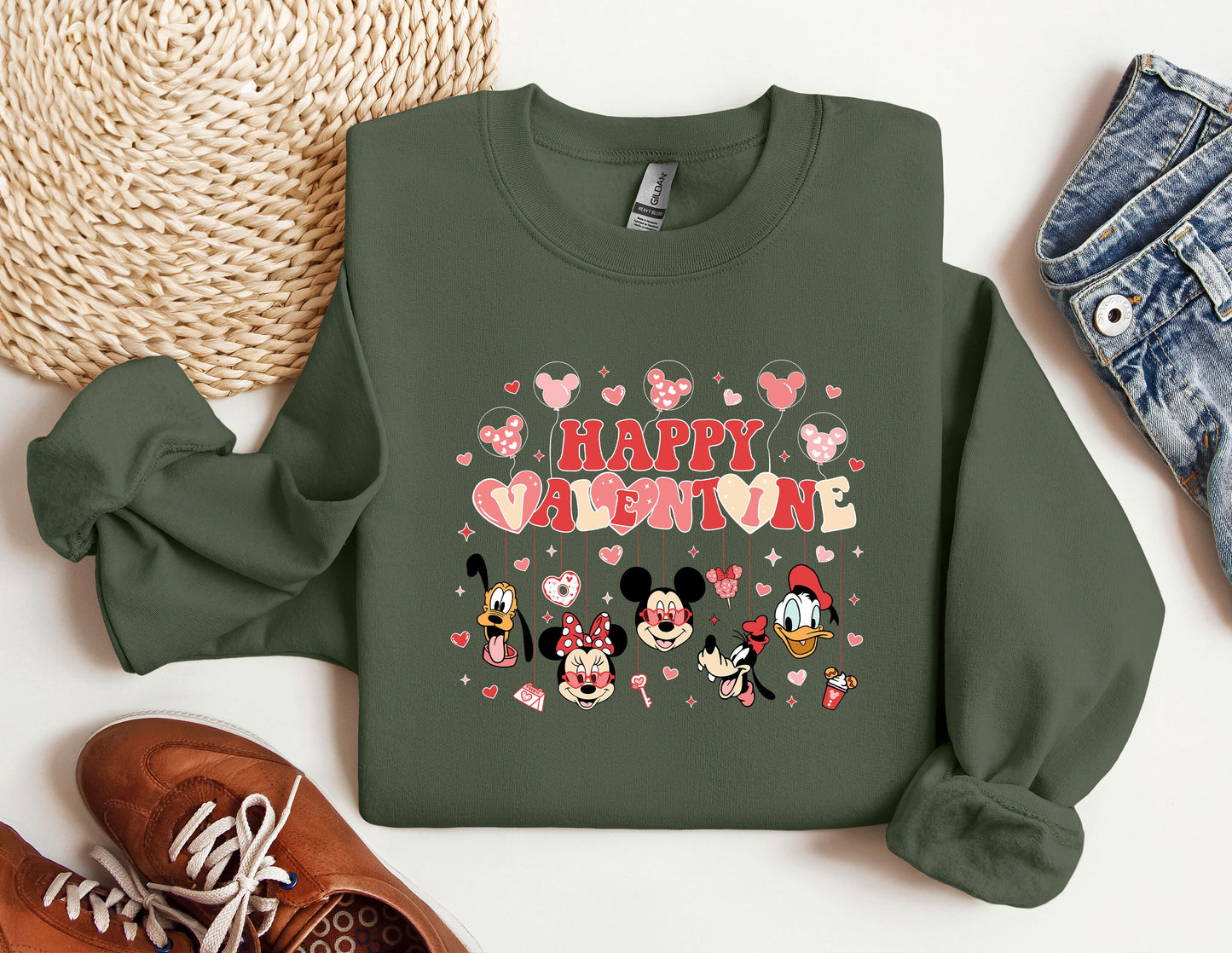 a green sweatshirt with mickey and minnie mouses on it