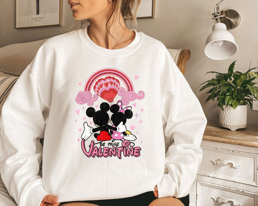 a woman wearing a mickey and minnie mouse sweater