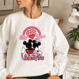a woman wearing a mickey and minnie mouse sweater
