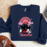 a blue sweatshirt with a black and white cow on it
