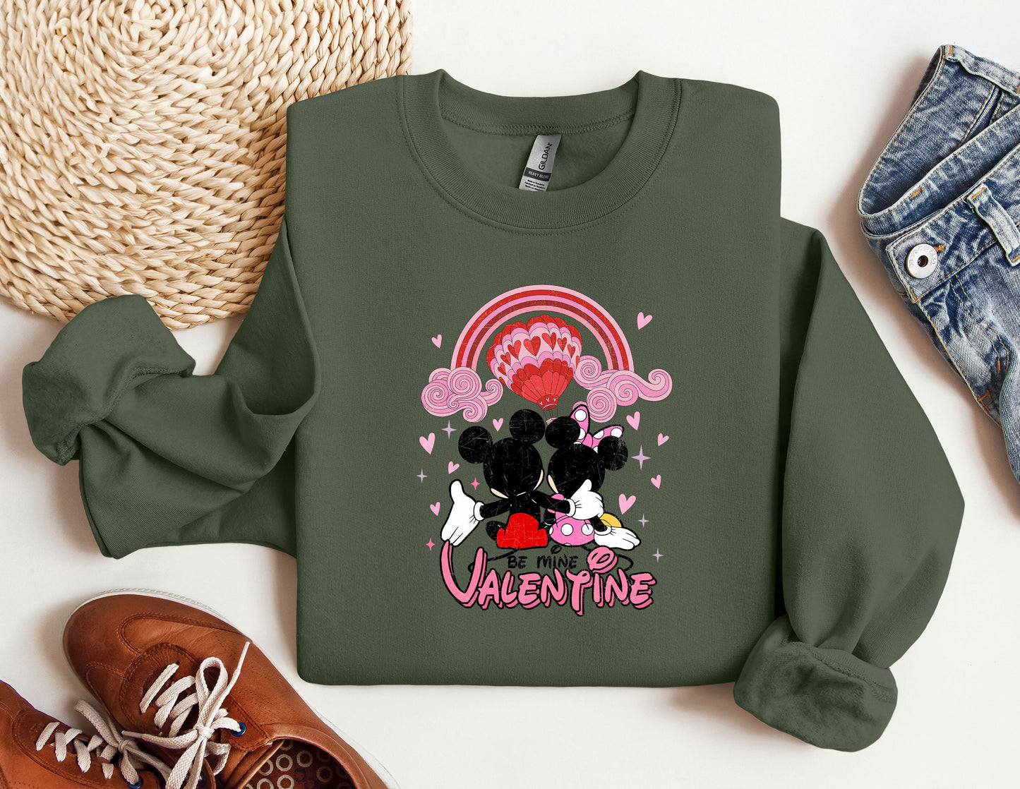 a green sweatshirt with a minnie mouse on it