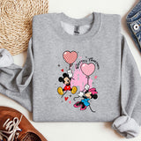 a gray sweatshirt with a mickey mouse design on it
