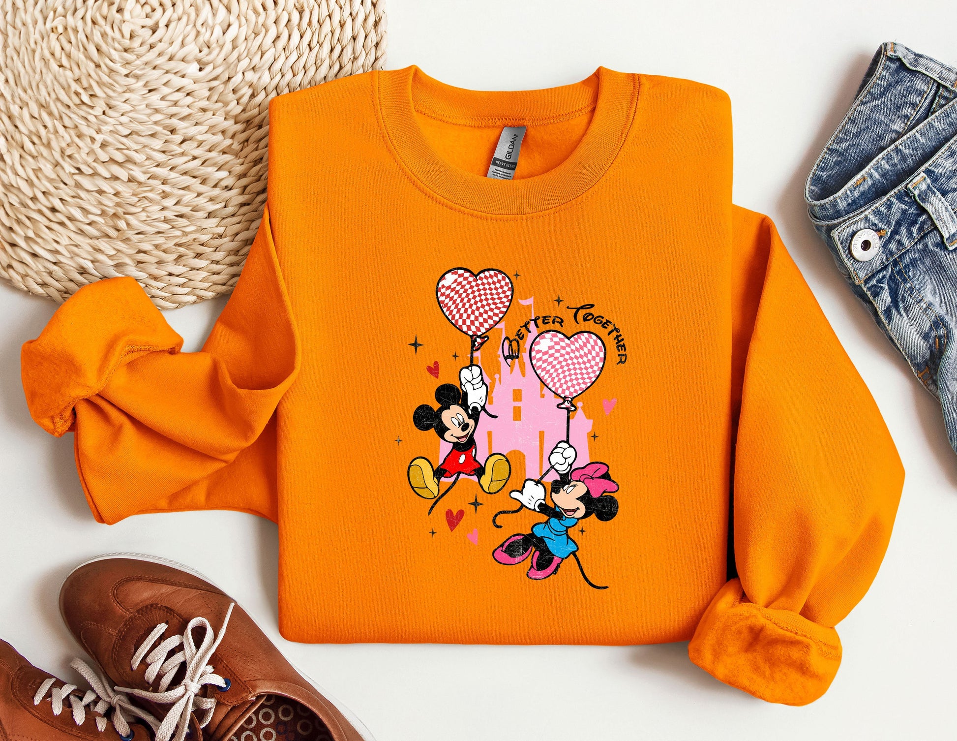 a pair of sneakers and a sweatshirt with mickey mouse on it