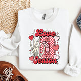 a white sweatshirt with the words love is in the center