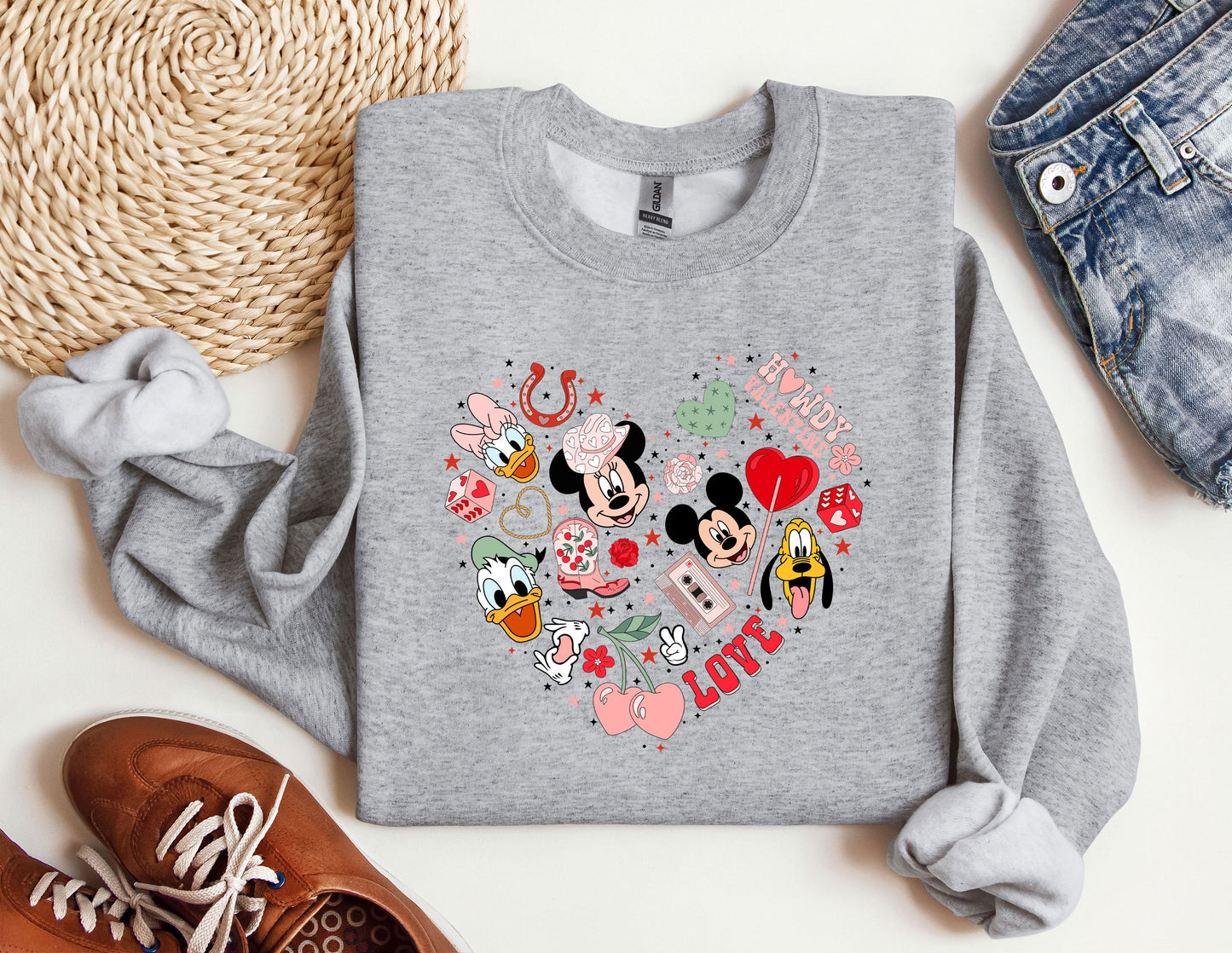 a mickey mouse heart sweatshirt sitting on top of a table