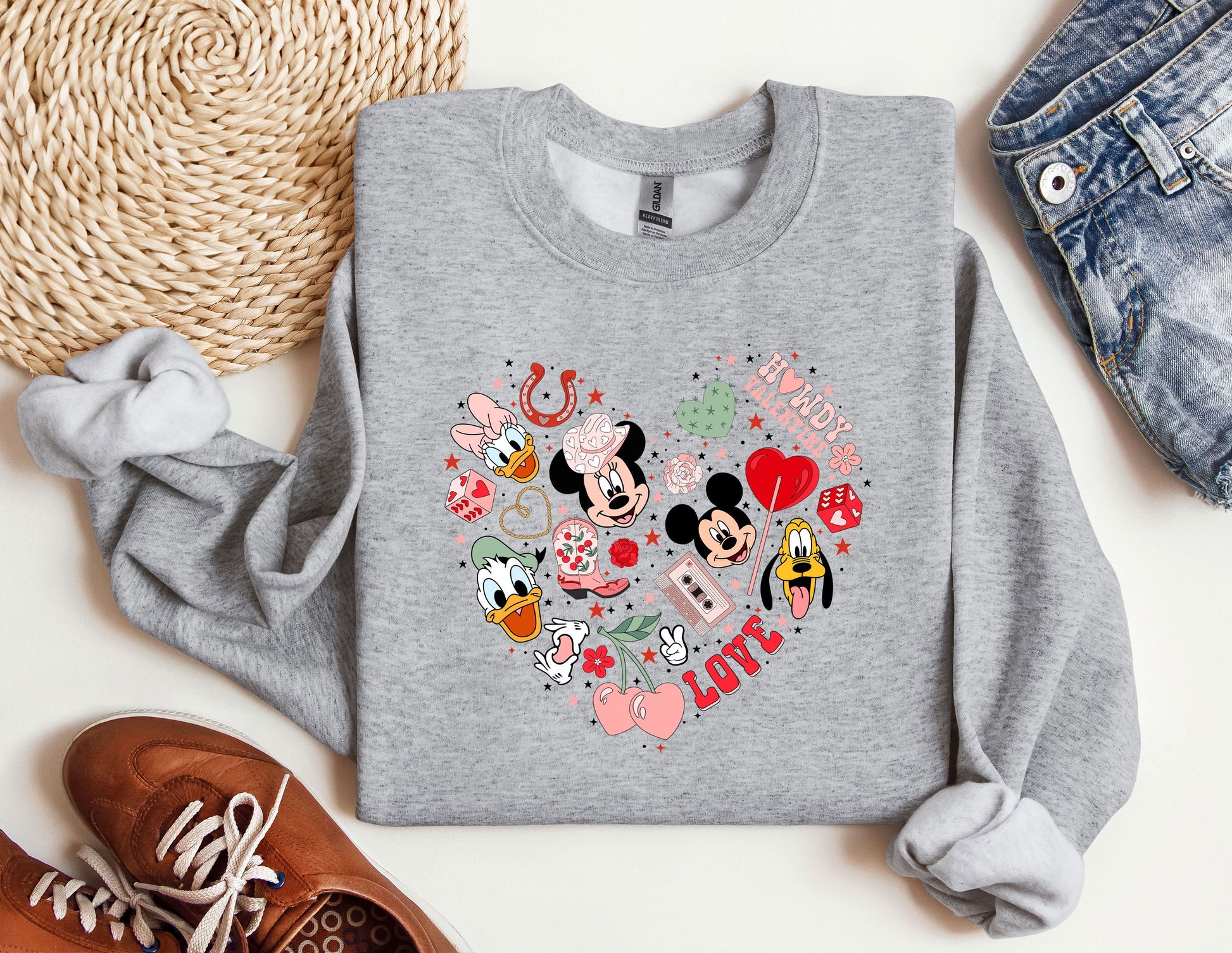 a mickey mouse heart sweatshirt sitting on top of a table