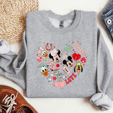 a mickey mouse heart sweatshirt sitting on top of a table