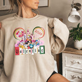 a woman wearing a mickey mouse sweatshirt with the word valentine on it
