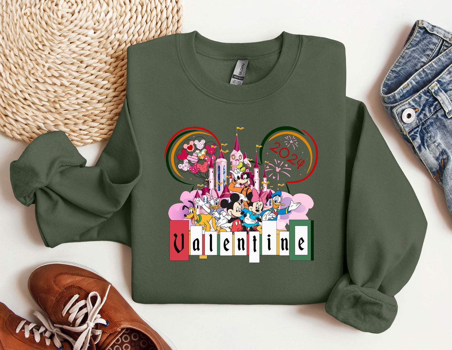 a green sweatshirt with mickey mouse and friends on it