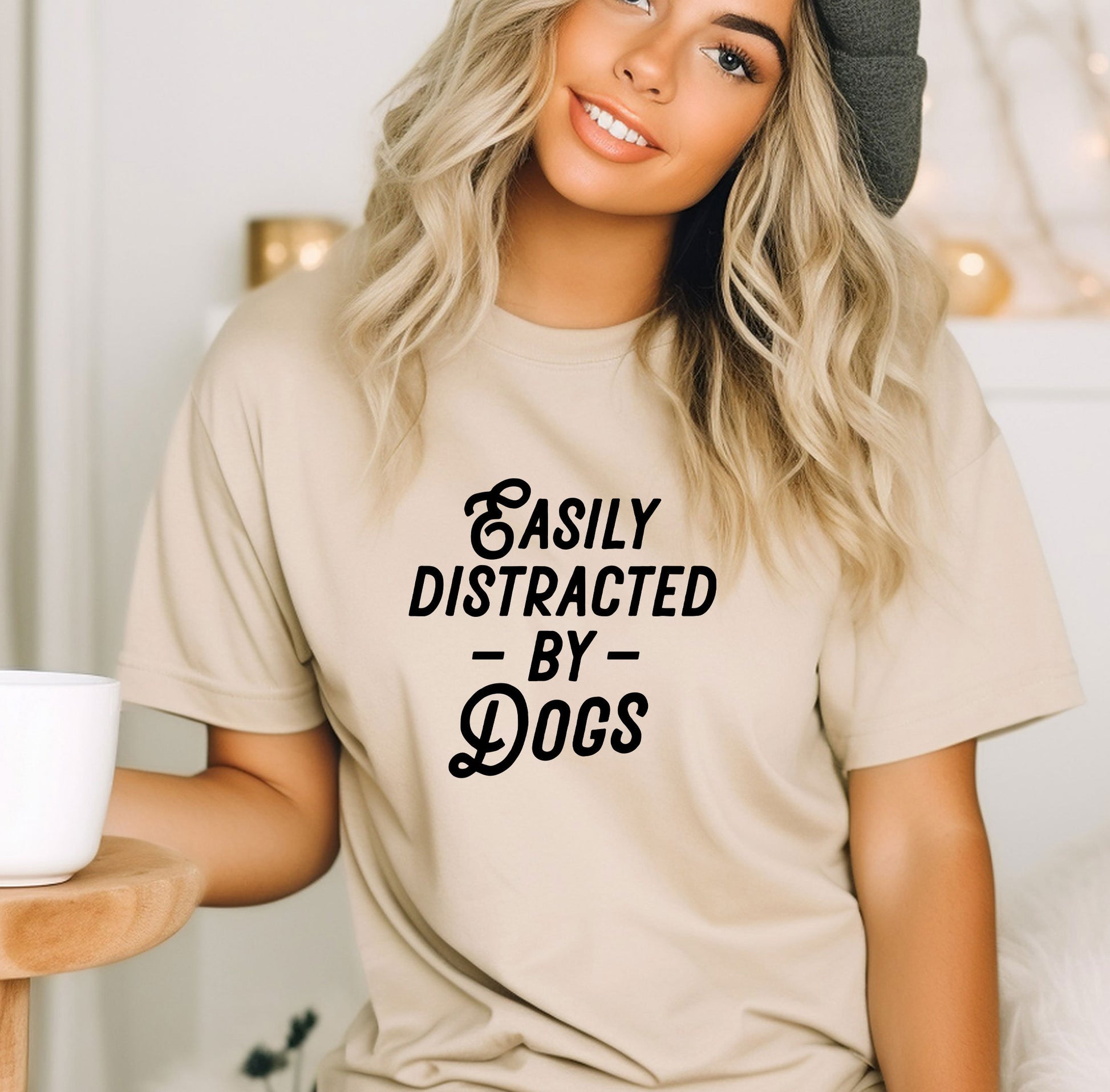 a woman wearing a t - shirt that says easily distracted by dogs