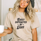 a woman wearing a t - shirt that says easily distracted by dogs