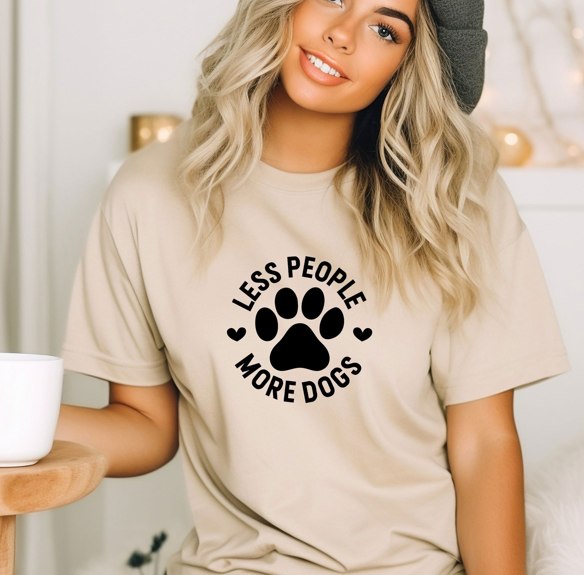 a woman wearing a t - shirt that says less people more dogs