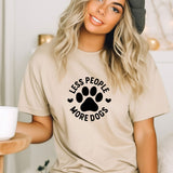 a woman wearing a t - shirt that says less people more dogs