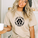 a woman wearing a t - shirt that says i just a girl who loves dogs