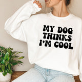 a woman wearing a sweatshirt that says, my dog thinks i'm cool