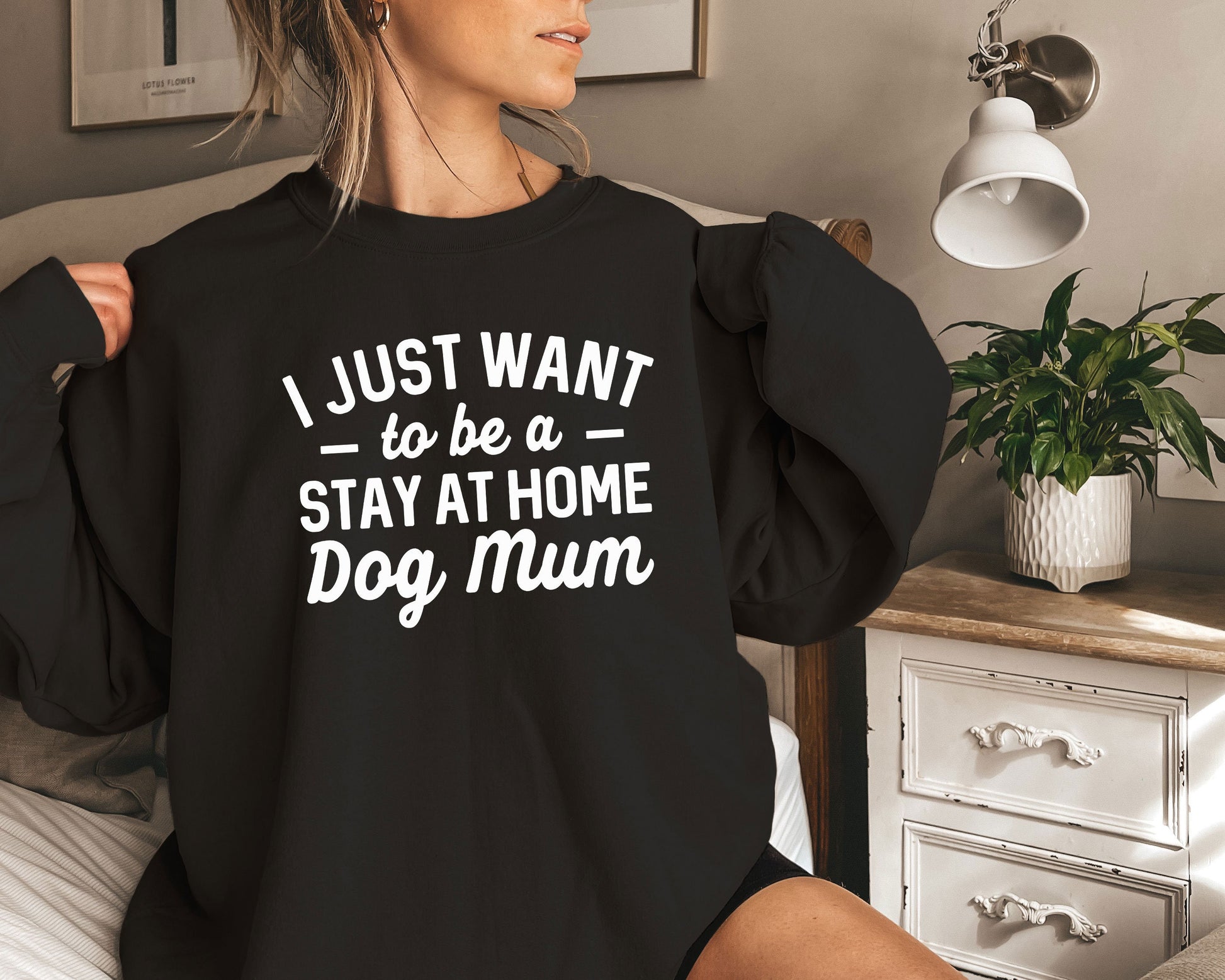 a woman sitting on a bed wearing a black shirt that says i just want to
