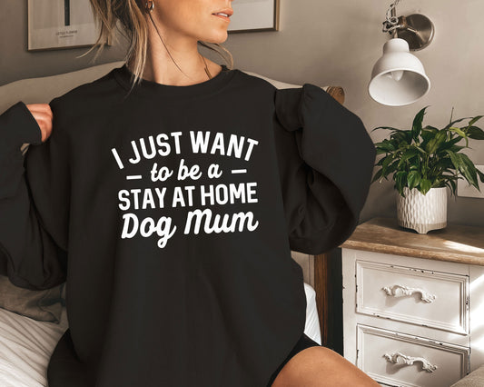 a woman sitting on a bed wearing a black shirt that says i just want to