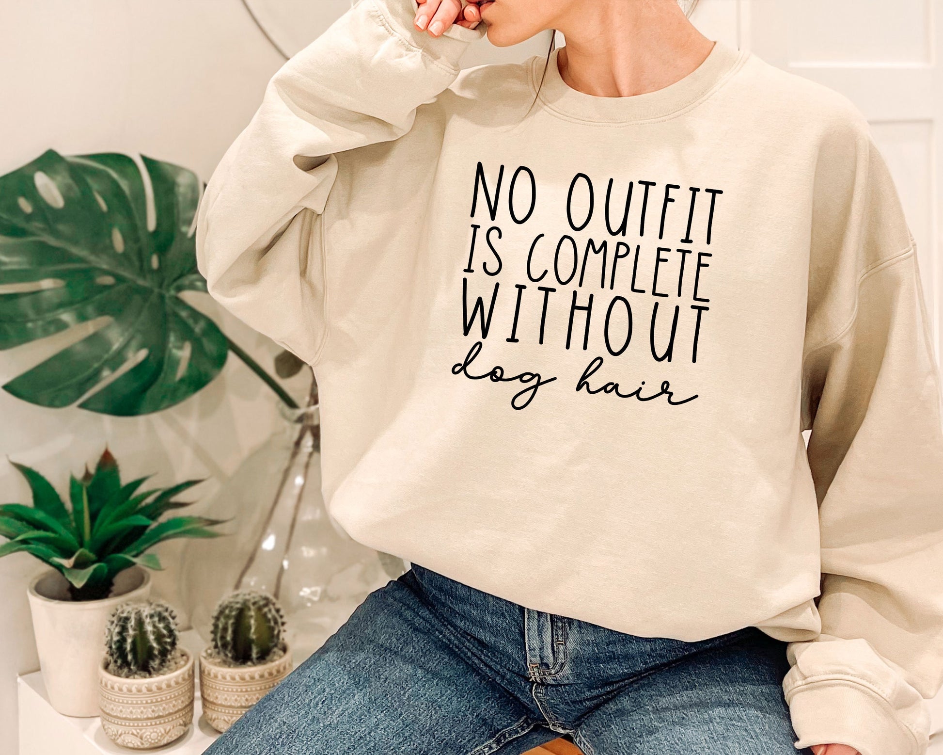 a woman wearing a sweatshirt that says, no outlet is complete without lazy hair