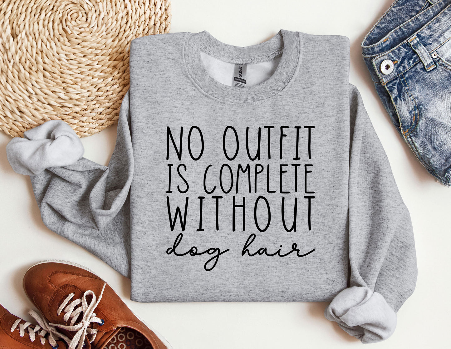 a sweatshirt that says, no outfit is complete without a hair