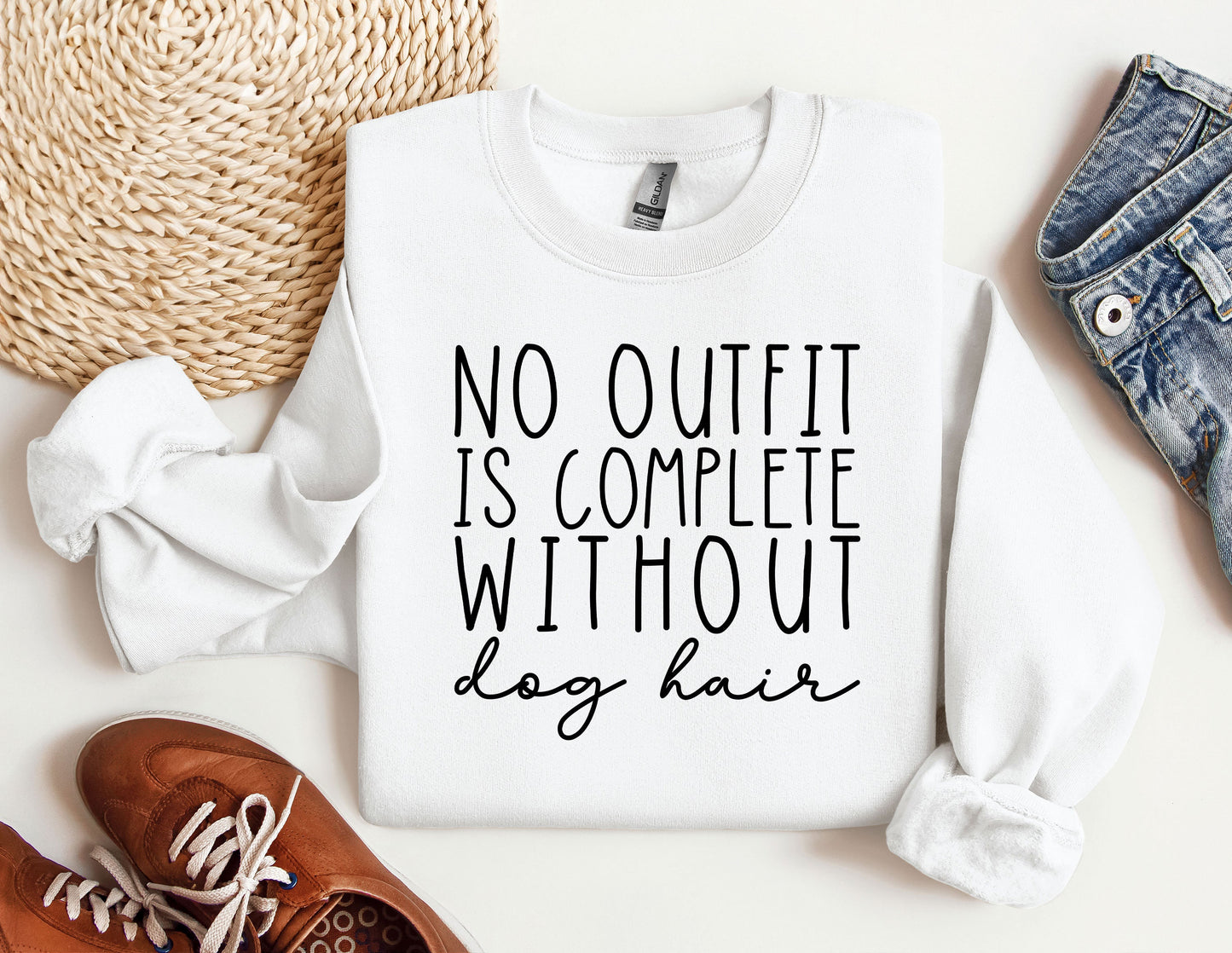 a white sweatshirt with a quote on it next to a pair of shoes