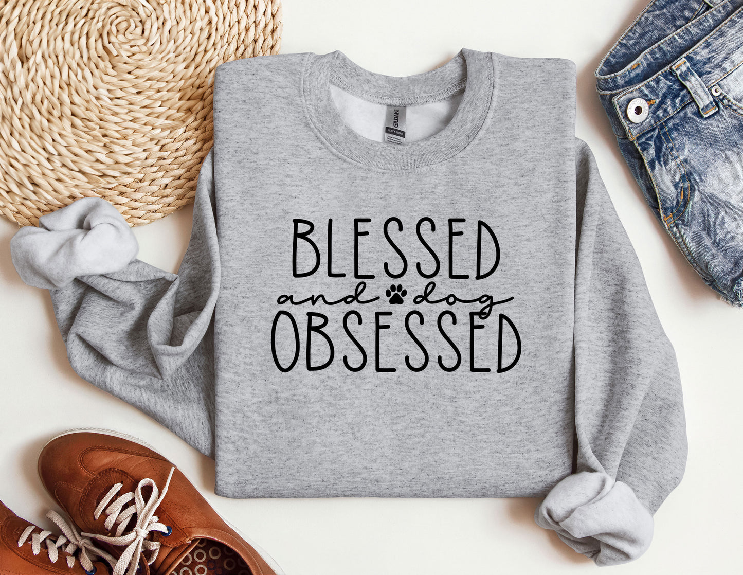 a sweatshirt with the words, blessing and dog obsesed printed on it