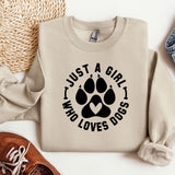 a sweater with a dog's paw on it next to a pair of shoes