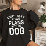 a woman sitting on a bed with a black shirt that says sorry i can '
