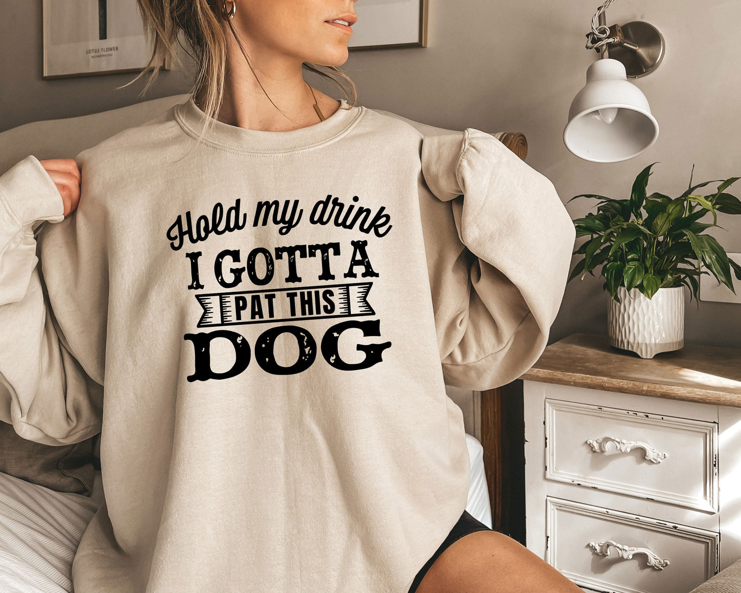 a woman wearing a sweatshirt that says, i gota eat this dog