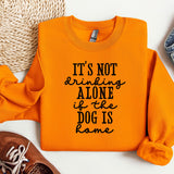an orange shirt with a slogan that says it's not drinking alone if the