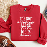 a red sweatshirt with a quote on it next to a pair of shoes