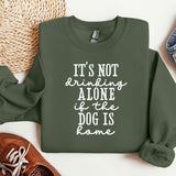 a green sweatshirt that says, it's not drinking alone if dog is bone