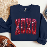 a pair of shoes and a sweatshirt on a table