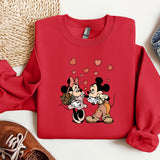 a red sweatshirt with a mickey and minnie kissing